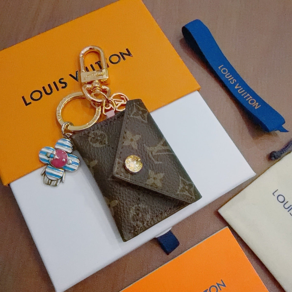 LV Brown Bag Charm With Blue Flower